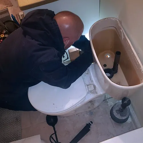 professsional working in toilet leak
