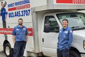 What is a Backflow Preventer; Columbia, SC - Picture of 2 employees in unifrom standing next to the company van.