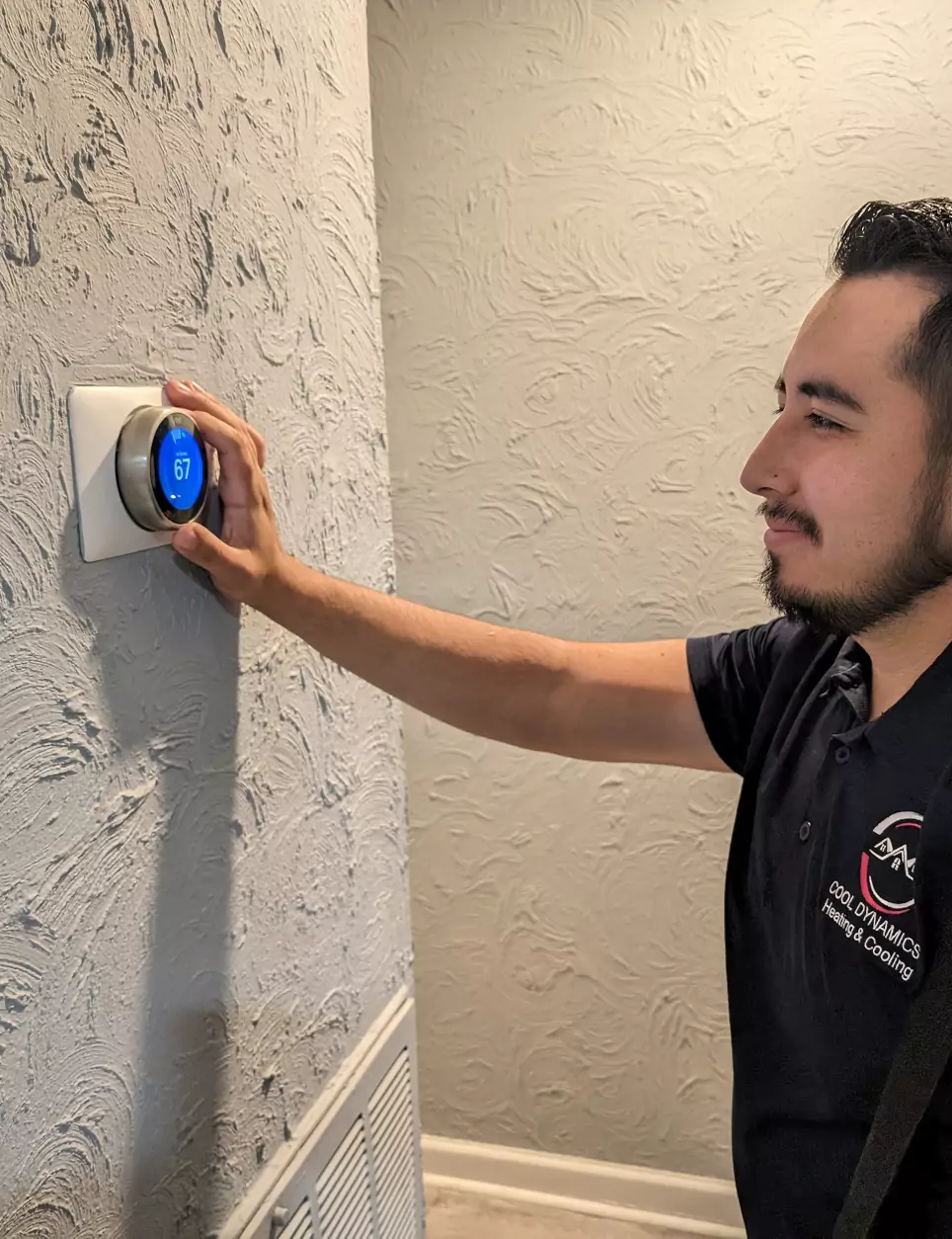 HVAC professional adjusting thermostat temperature from cool to heat mode