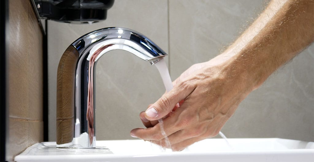 ADA-compliant bathroom plumbing installing a Touchless-faucet